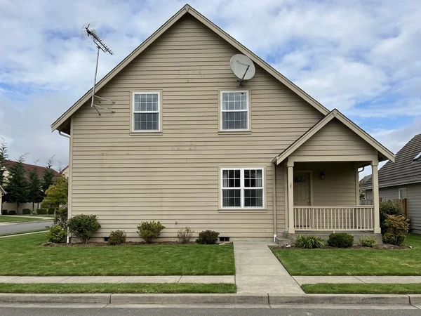Dark gray house facade before AI color preview, neutral entry door