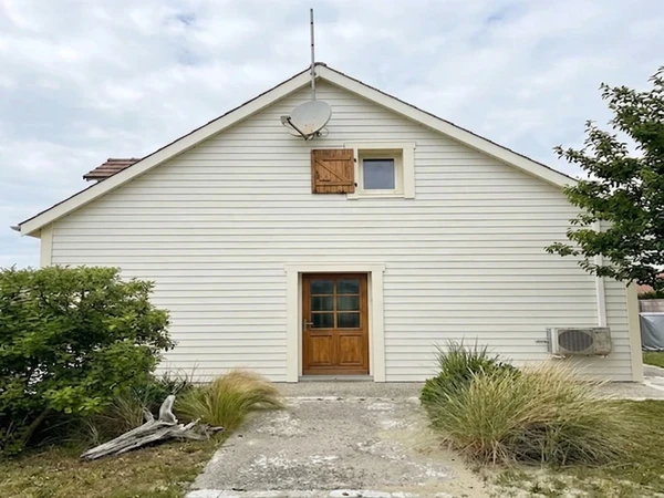 Cape Cod exterior in Behr Polar Bear 75 with warm trim, AI color preview